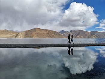Man standing on mountain against sky