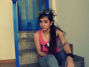 Portrait of young woman sitting outdoors