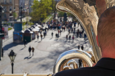 Rear view of people playing on tuba on balcony
