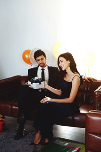 Young couple sitting on sofa
