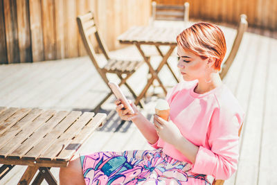 Young woman sitting on table