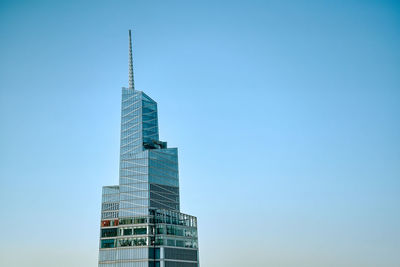 Low angle view of skyscrapers against clear blue sky