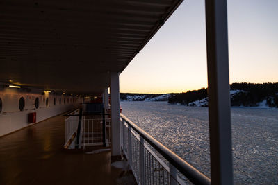 Bridge over sea against sky during sunset