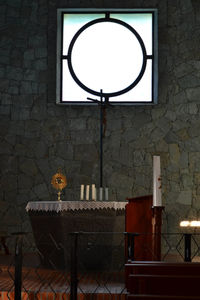 Electric lamp on table against wall at home