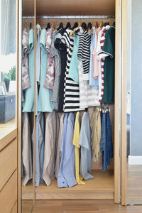 Clothes hanging in wardrobe