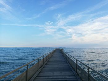 Pier over sea against sky