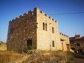 Low angle view of old ruins against sky