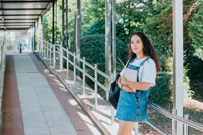 Full length of young woman standing in city