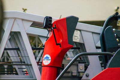 Close-up of red stop sign on railing