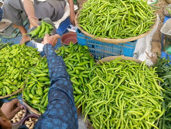 Cropped hand of man buying vegetables at market