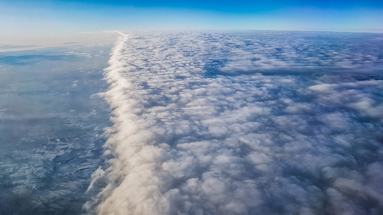 AERIAL VIEW OF CLOUDSCAPE OVER AIRPLANE