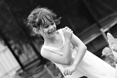 Smiling girl standing outdoors