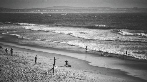 People on beach against sky