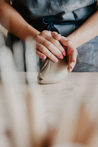 Close-up of woman holding hands on table