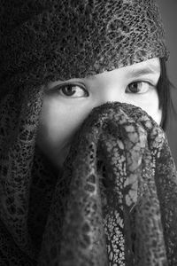 Close-up portrait of girl covered with shawl