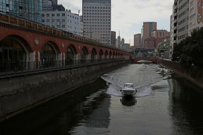 Bridge over canal amidst buildings in city