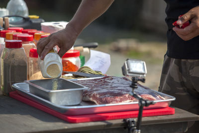 Mid section of a man preparing food