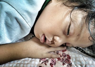 Close-up of girl sleeping on bed