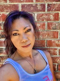 Portrait of woman against wall