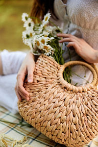 Midsection of woman holding bouquet