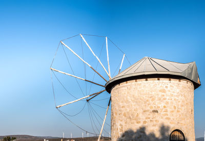 Low angle view of water tower against blue sky