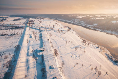 Aerial view of snow covered landscape against sky