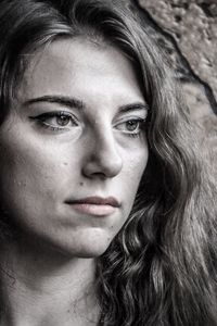 Close-up of thoughtful woman with long hair looking away