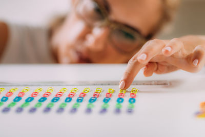 Woman with ocd. obsessive compulsive disorder concept. placing paperclips in a straight line.