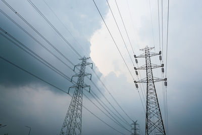 Low angle view of electricity pylon against sky