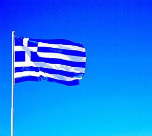 Low angle view of flag against clear blue sky