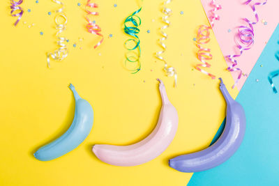 High angle view of multi colored splashing water against yellow background