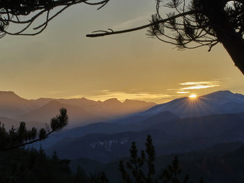 Scenic view of silhouette mountains against sky at sunset