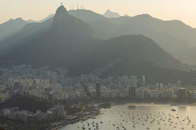 High angle view of townscape and mountains against sky during sunset