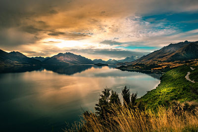 Scenic view of lake against sky during sunset