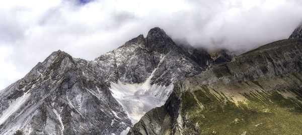 Low angle view of rocky mountain against sky