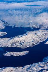 Aerial view of snowcapped mountains against sky