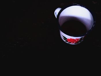 High angle view of coffee cup against black background