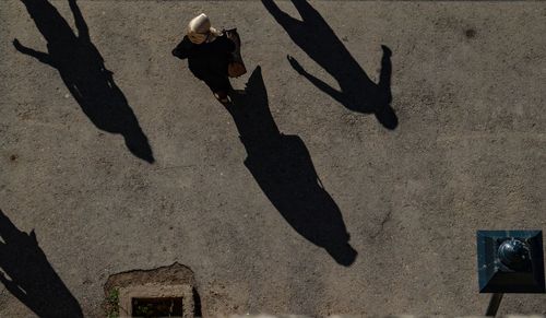 High angle view of people walking on road