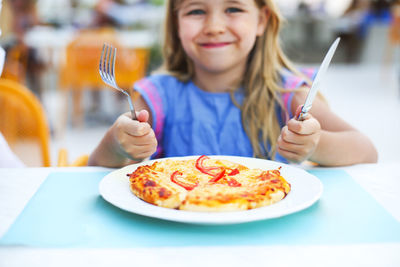 Portrait of girl with ice cream in restaurant