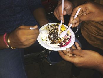 Midsection of woman eating food