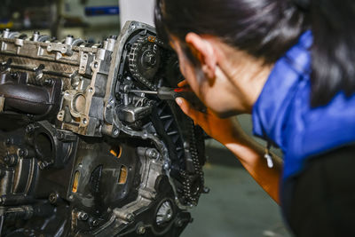 Side view of man repairing car