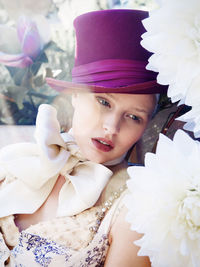 Woman in dress and hat looking away outdoors