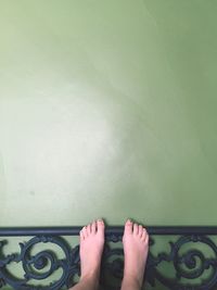 Low section of woman standing on tiled floor