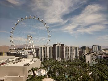 Ferris wheel in city against sky