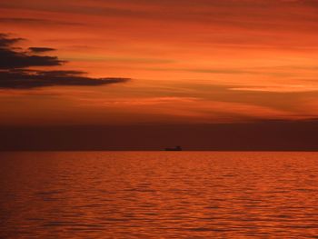 Scenic view of sea against romantic sky at sunset