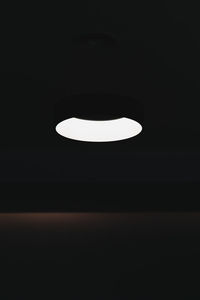 Low angle view of illuminated light bulb in the dark