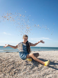 Full length of woman standing at beach