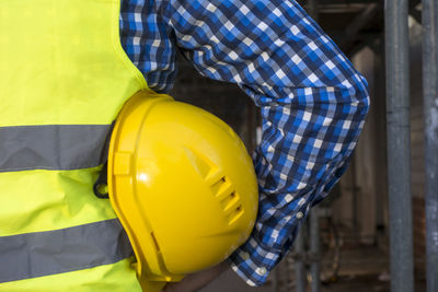 Midsection of man holding balloons