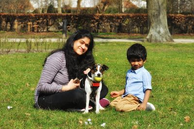 Siblings sitting in park