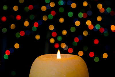 High angle close-up of glowing candle during christmas